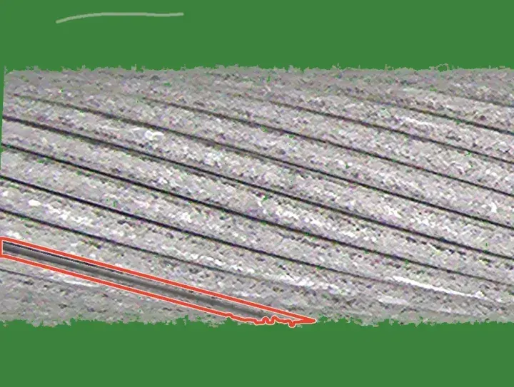Training crop at the strip end with a drawn spaced strand: a dark groove opens along one strand and runs out of view at the left; its mask is outlined in red.